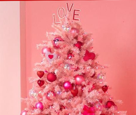 pink colored Christmas tree with a topper that says LOVE.